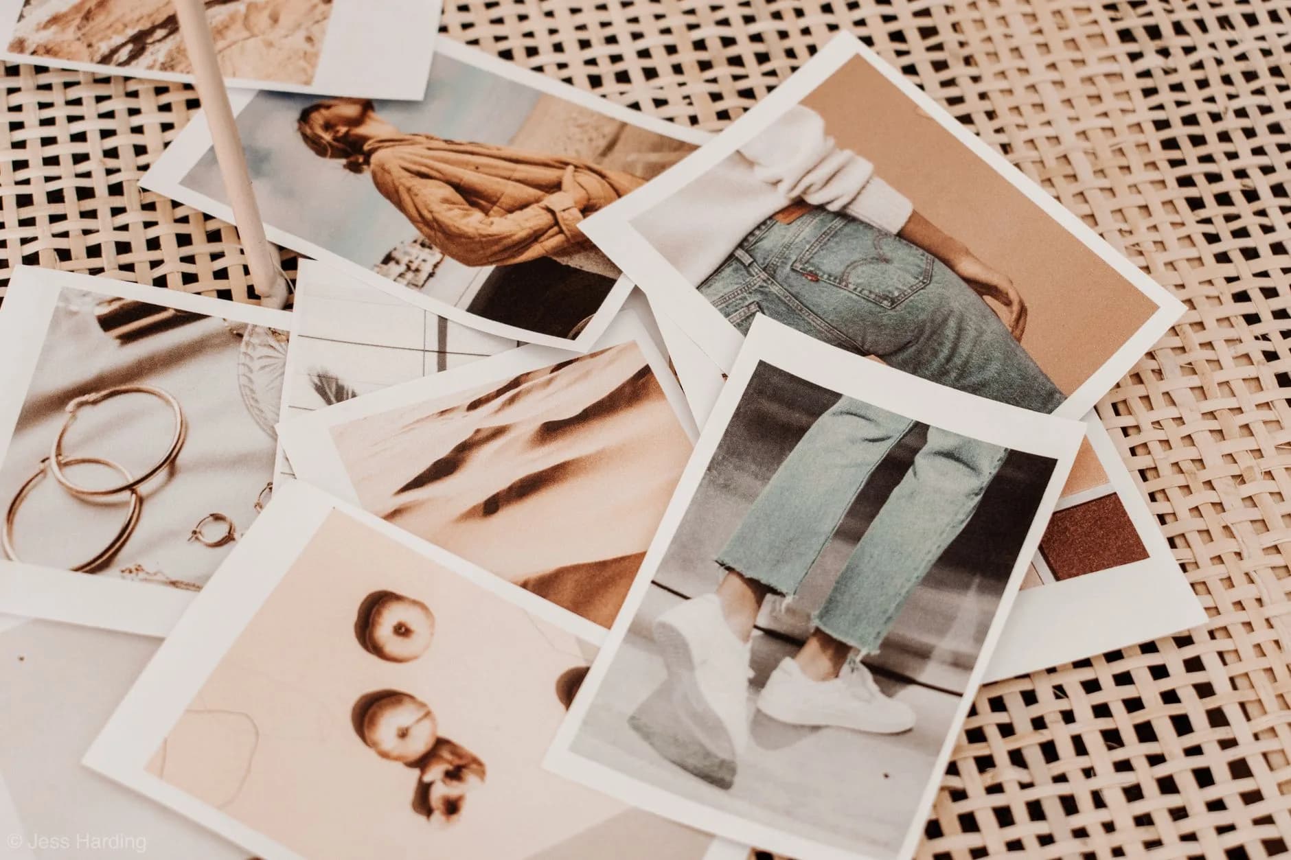 Bunch of instant photos of woman trendy outfits and accessories placed on table